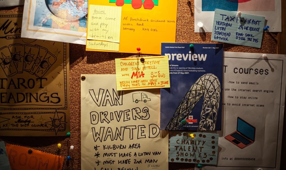 A noticeboard of flyers and leaflets advertising various jobs and events in and around Brent.